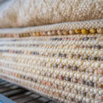 Handwoven rug fibres shown in a close-up view.