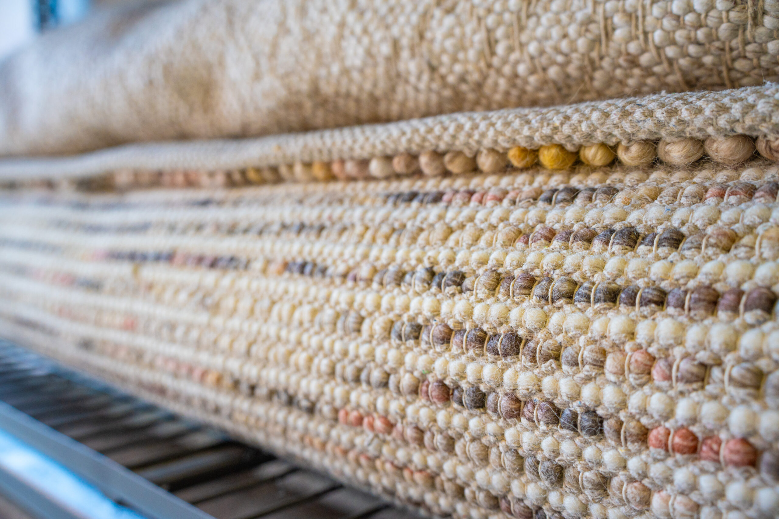 Handwoven rug fibres shown in a close-up view.